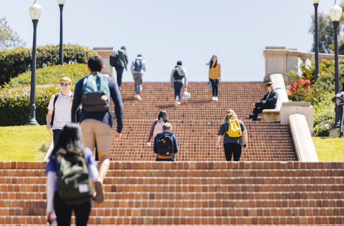 Students walking outside on a brick staircase on UCLA campus