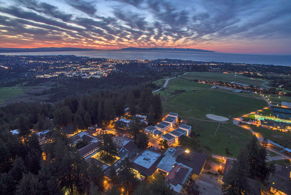 Aerial photo of Santa Cruz campus from above at sunset