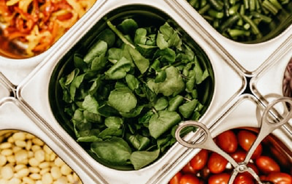 Salad bar zoomed in on bowl of spinach image