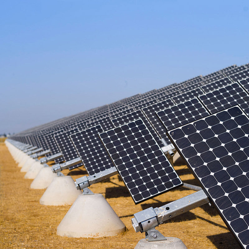 UC solar panels in a field under a blue sky