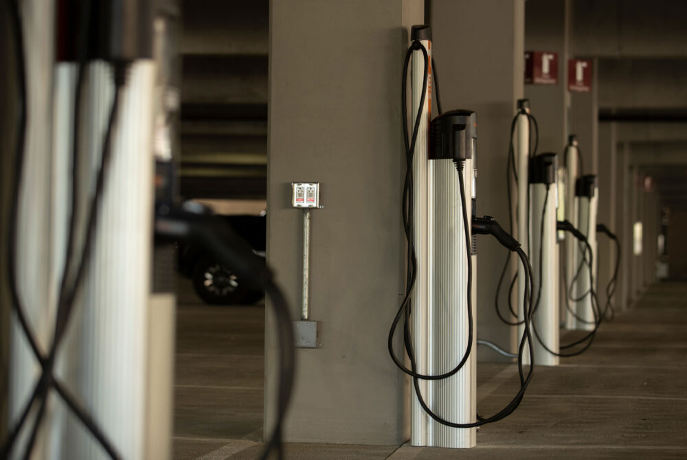 Line of UCR EV chargers in a parking garage