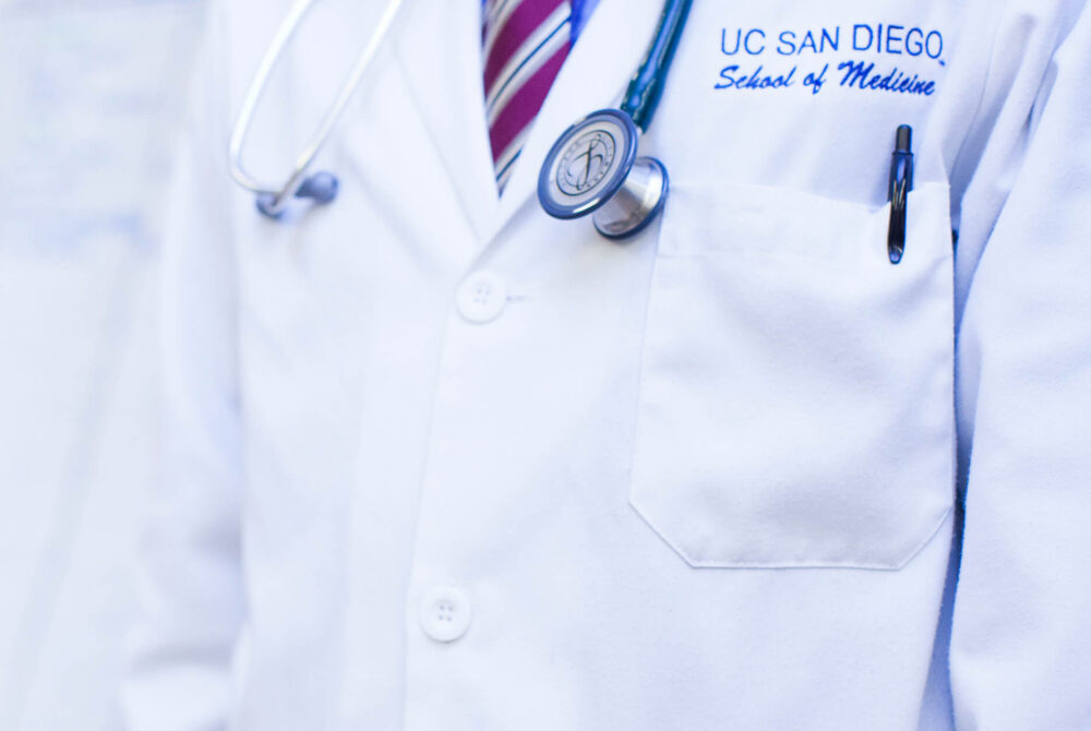 Doctor wearing a UC San Diego School of Medicine lab jacket with stethoscope