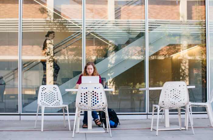 Student working on computer outside of UCLA Health building