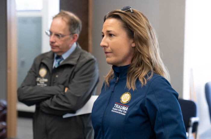 Coronado Bridge Suicide Prevention Tour, female TRAUMA worker standing, listening to someone speak