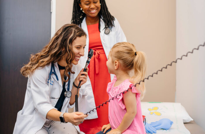 Female nurse/doctor examining the eyes of young female patient