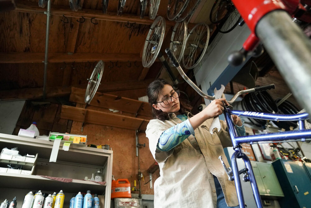 Amanda Lei, a third year Sustainable Environment and Design major, works on a bike at the Bike Barn