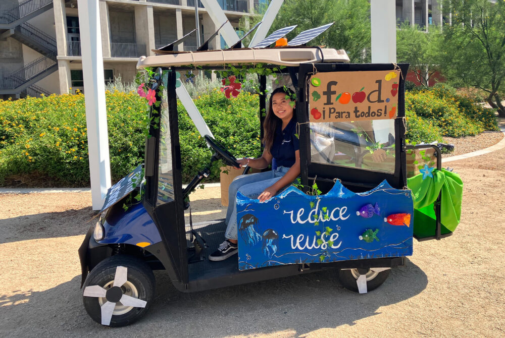 A golf cart decorated for sustainability.