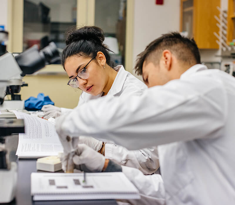 Two students at UC Santa Barbara working in a lab