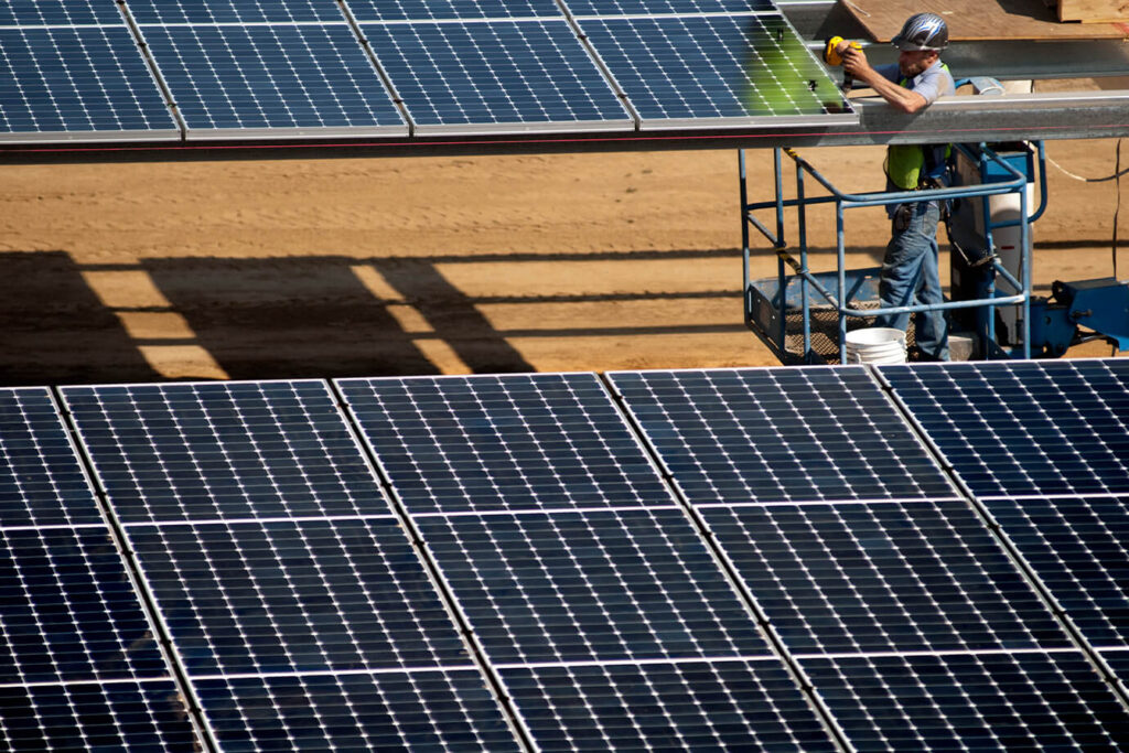 UCD workers instal parking lot solar panels at West Village