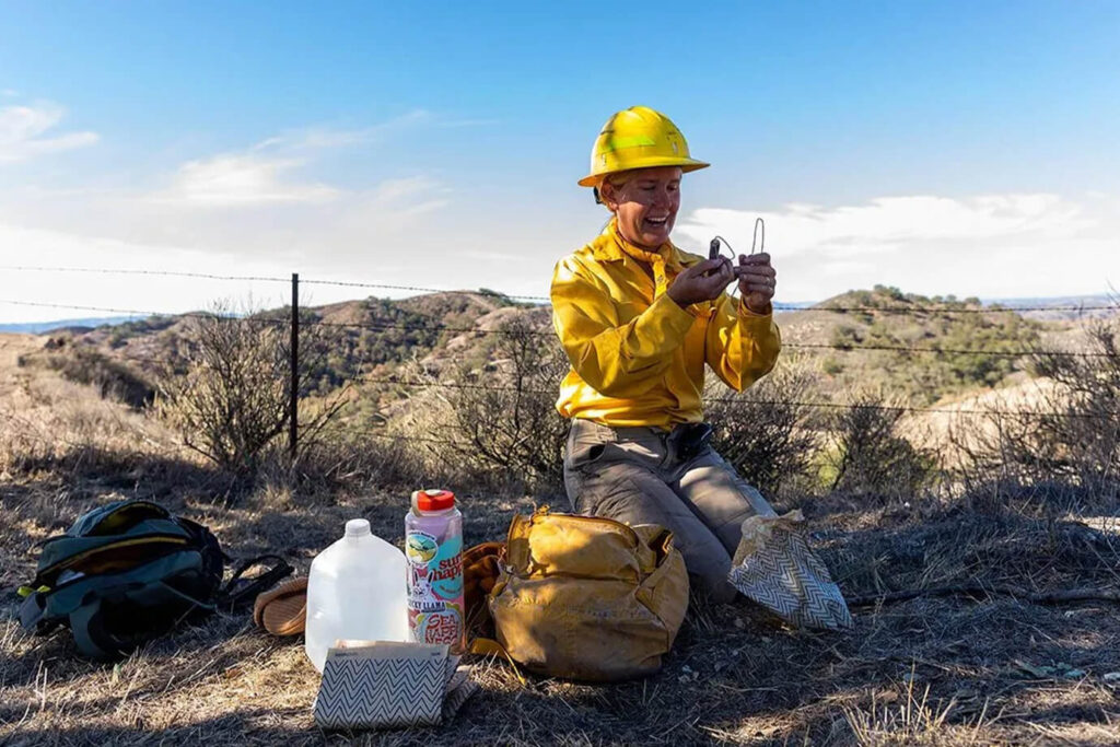 An ecologist positions equipment in the burn unit to collect data on the fire's spread and intensity at the Sedgwick Reserve Fire Treatment.