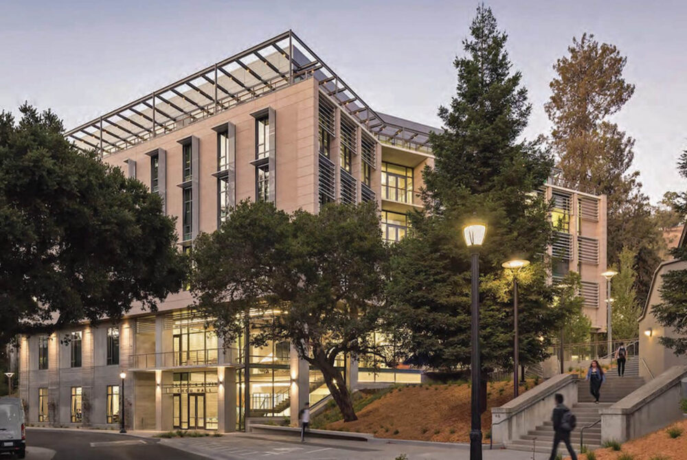 Students walking on campus in front of building
