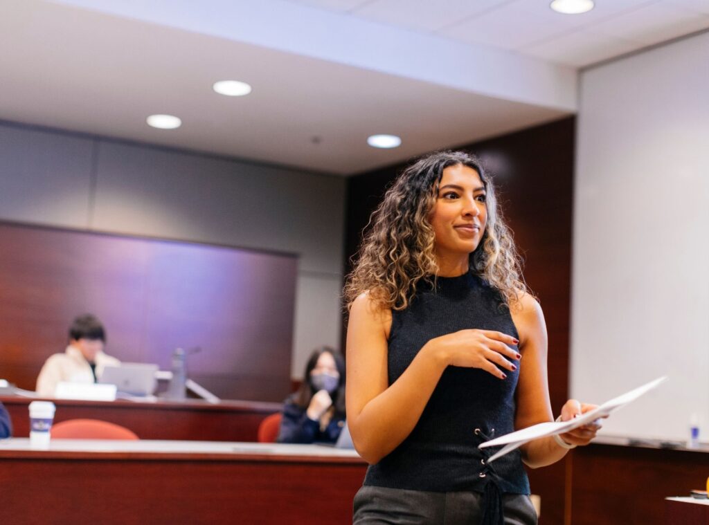 Person standing in the front of a classroom