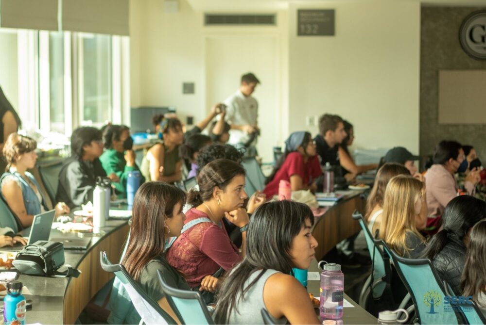 UCB students at desks for the climate justice panel