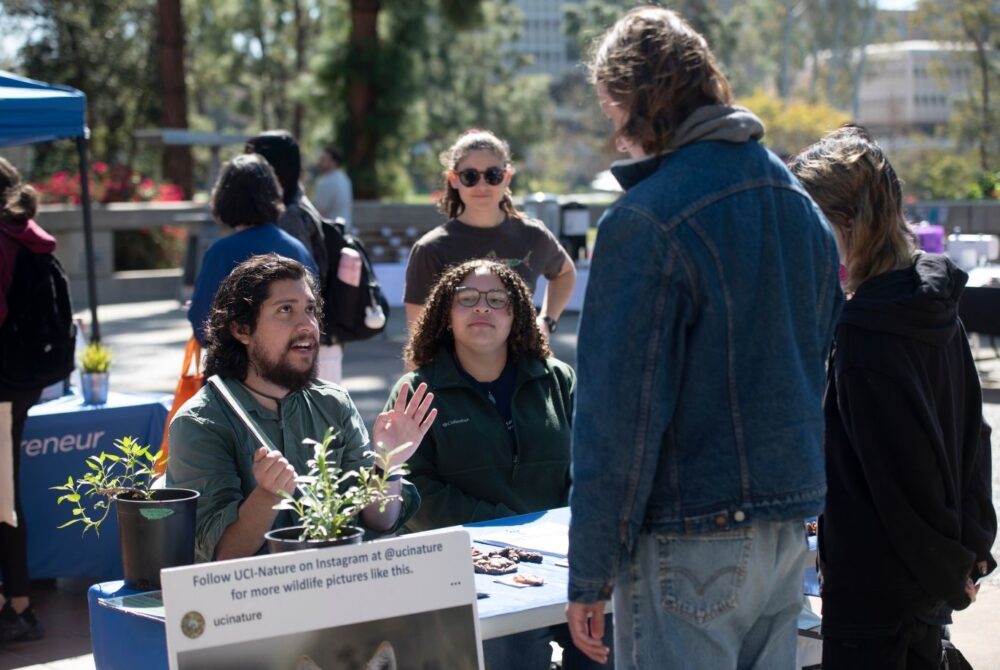 Students at a table for the UC Irvine "Sustainival" event